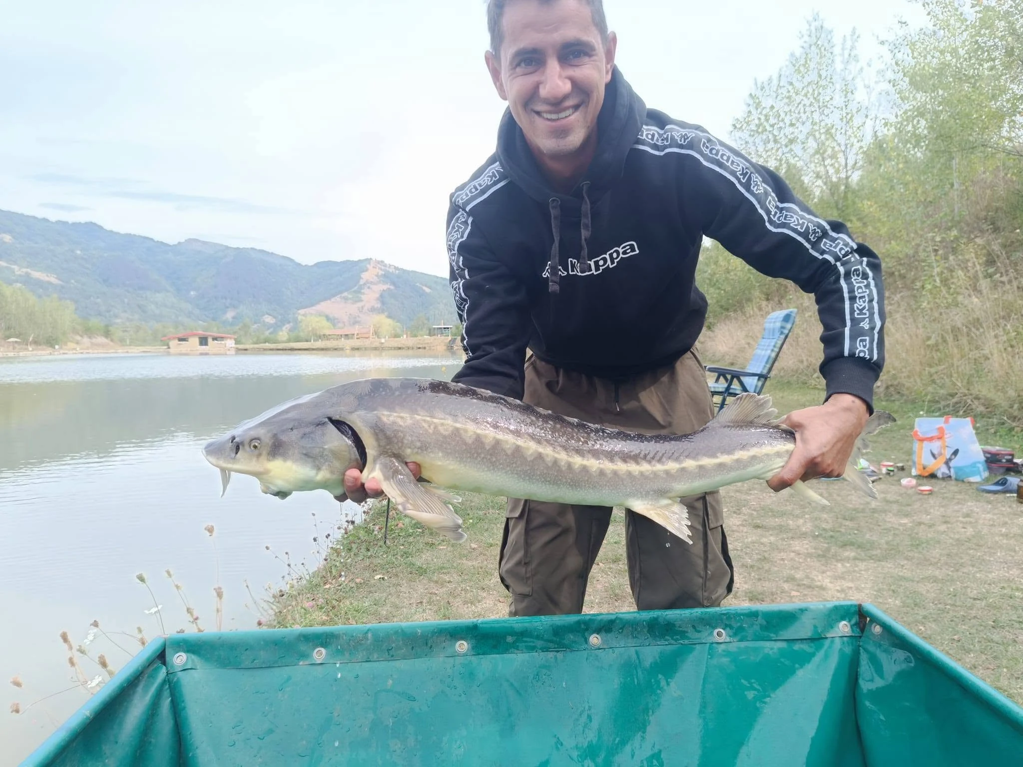 Pescar cu un sturion lângă salteaua de primire
